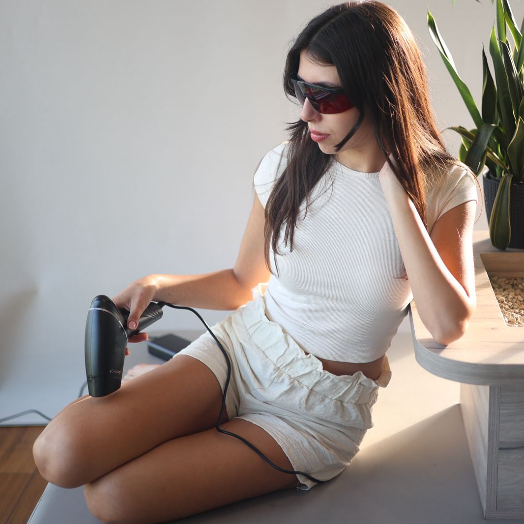 Woman using the OroSkin Ultra Sapphire IPL handset on her legs at home