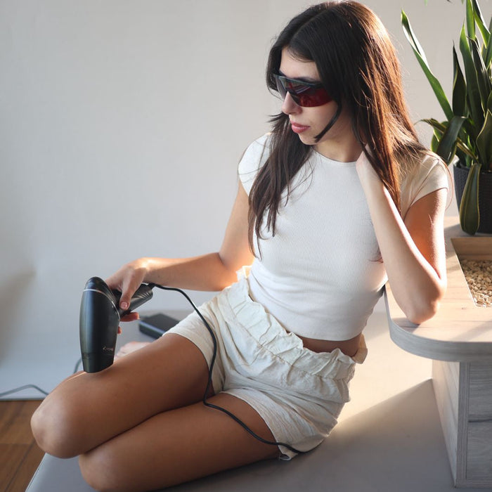 Woman using the OroSkin Ultra Sapphire IPL handset on her legs at home